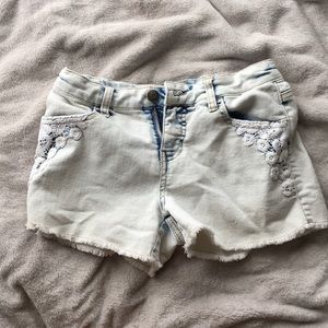Acid wash jean shorts with floral decal